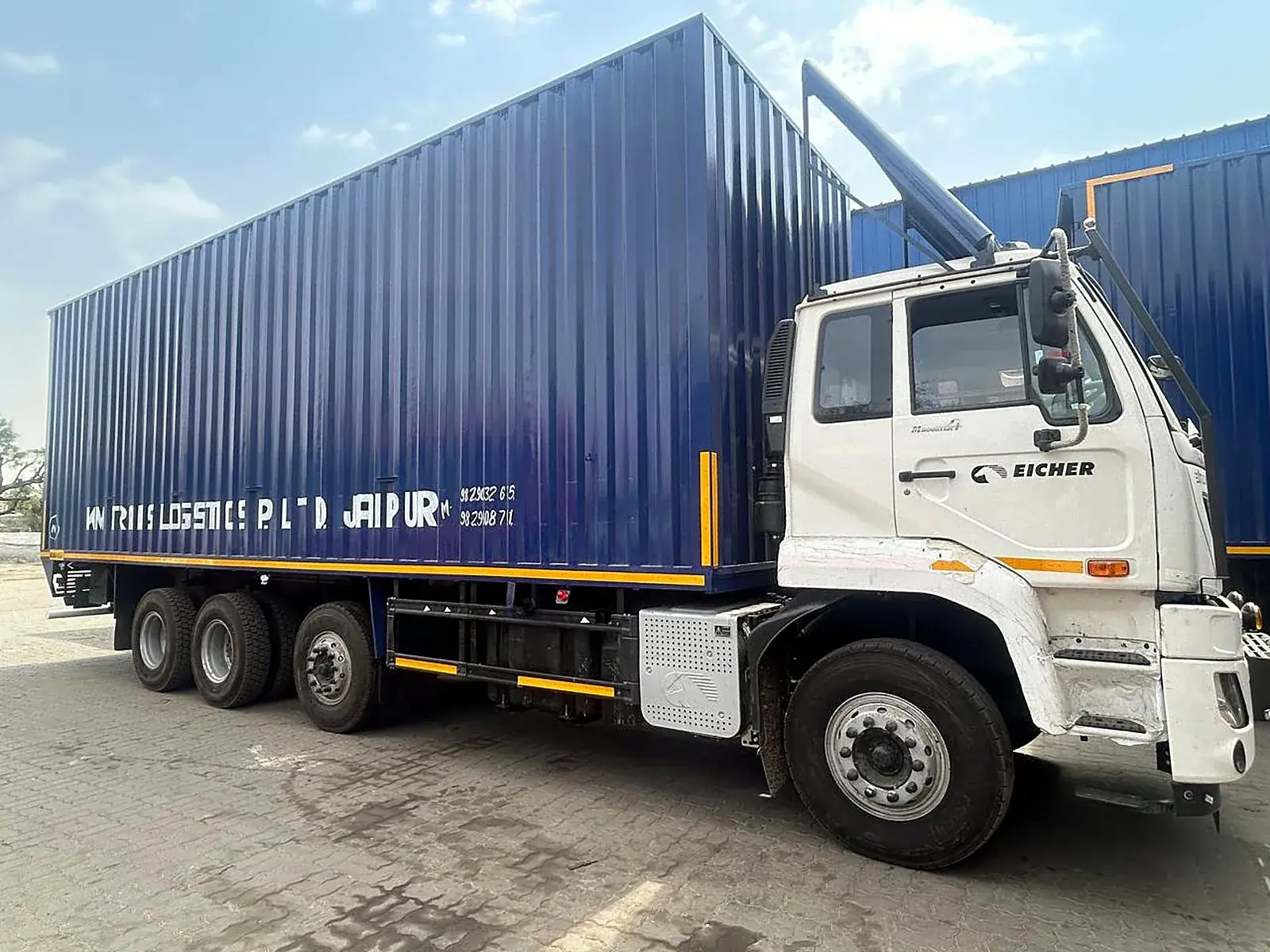 Eicher truck carrying a blue container