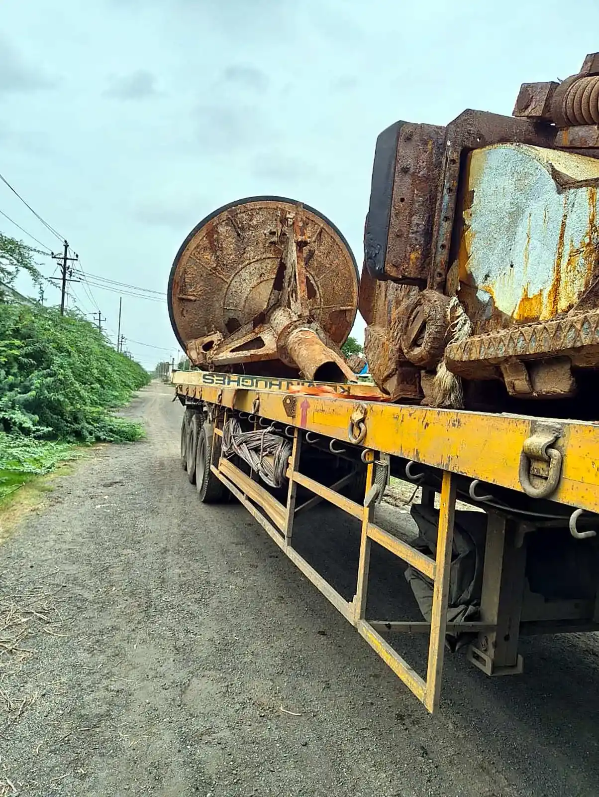 Heavy machine parts on a flatbed trailer